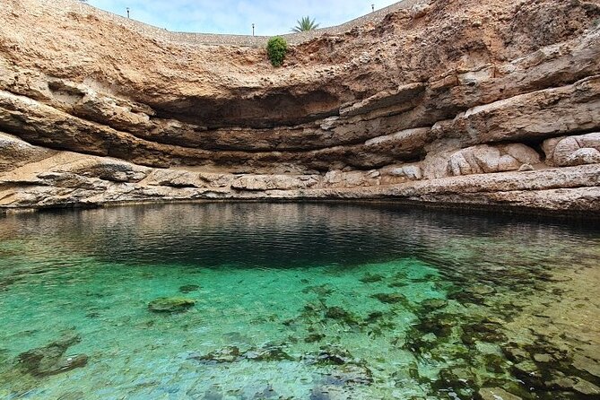 Full Day Group Tour to Wadi Shab Bimmah Sinkhole and Fins Beach - Bimmah Sinkhole and Hawiyat Najm, a Meteor Legend by the Sea