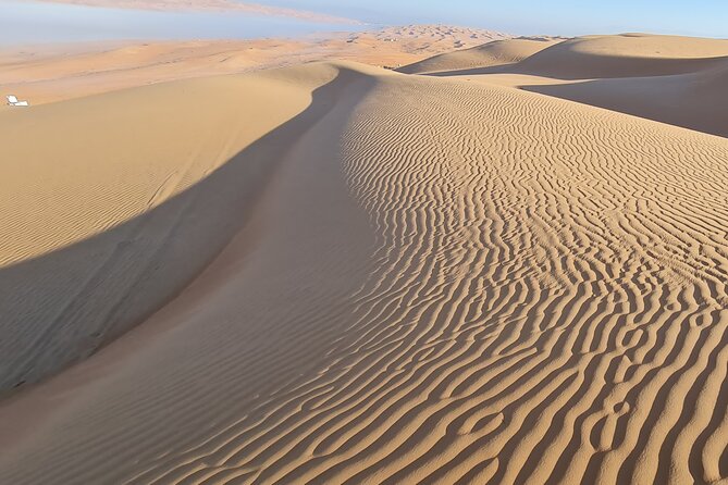Oman Highlights: Wahiba Sands Desert & Wadi Bani Khalid Tour - Wahiba Sands: Bedouin family welcome with coffee, dates, and photos